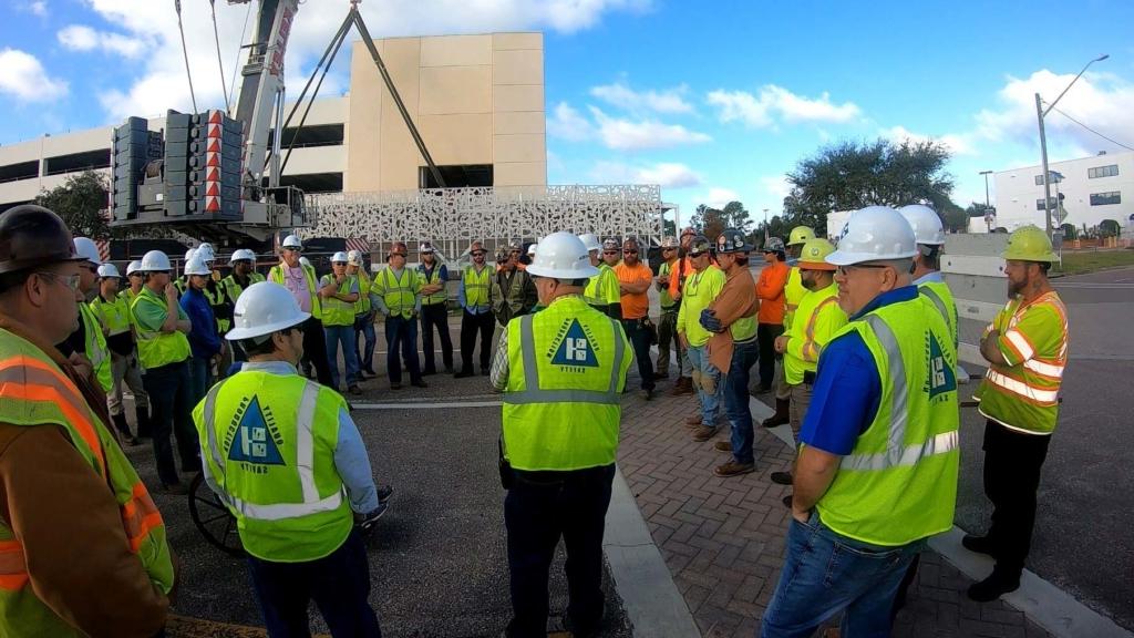 澳门足彩app team members participating in a safety meeting on a job site.