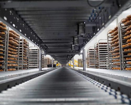 Quik Trip conveyor system flanked by portable racks filled with baked goods