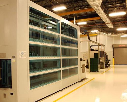 Interior of Turbomeca TMM Manufacturing Facility. Large industrial room with florescent lighting.