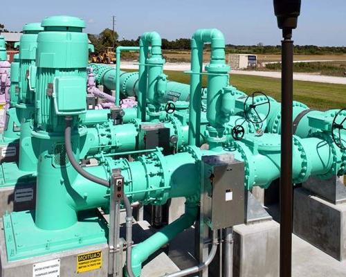 Green pipes and motors outside the facility